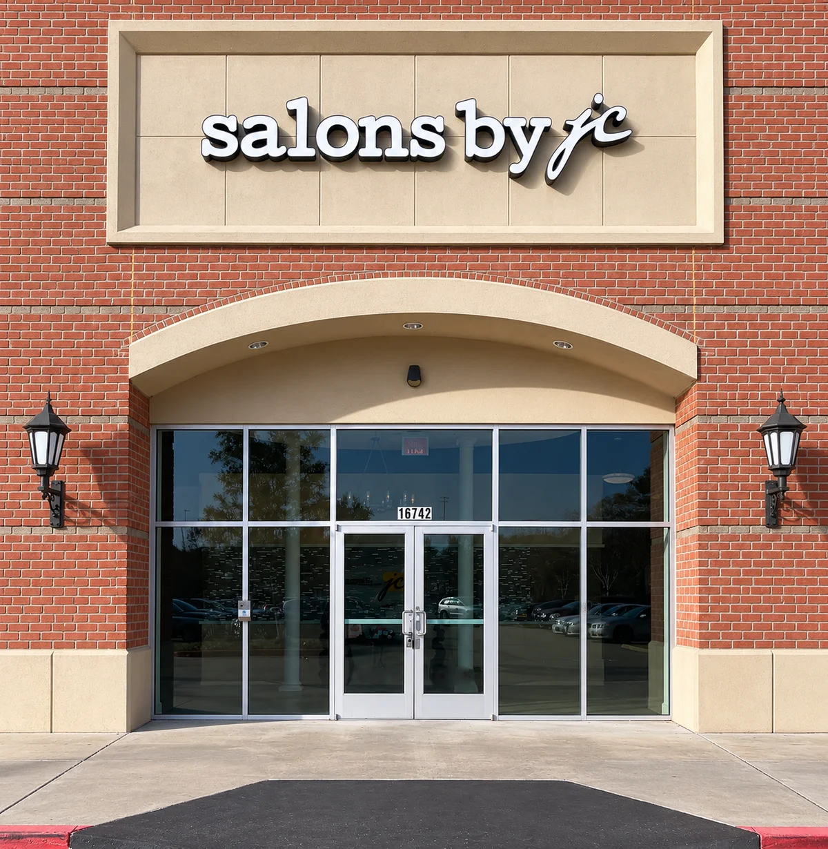 The Salons by JC building at 16742 Southwest Fwy, Sugar Land — Nails Unlimited moves into Ste 1 here, and the street number 16742 is above the doors